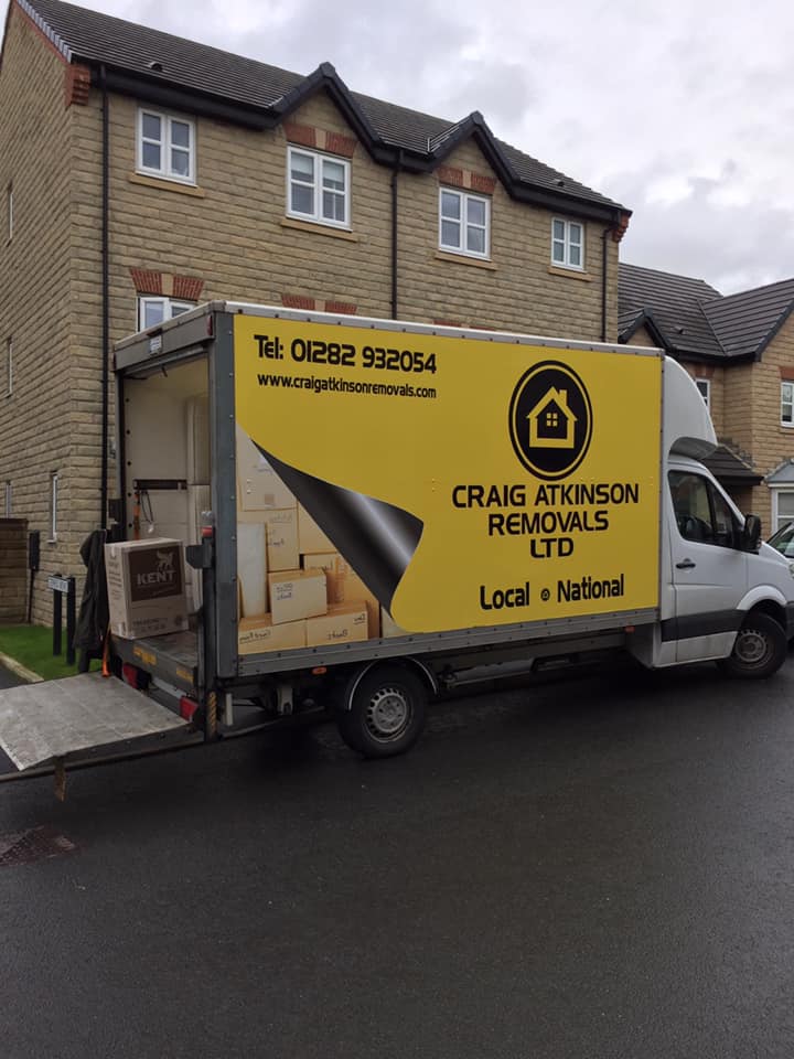 Craig Atkinson Removals van partially loaded outside a residential home during a shared delivery run.