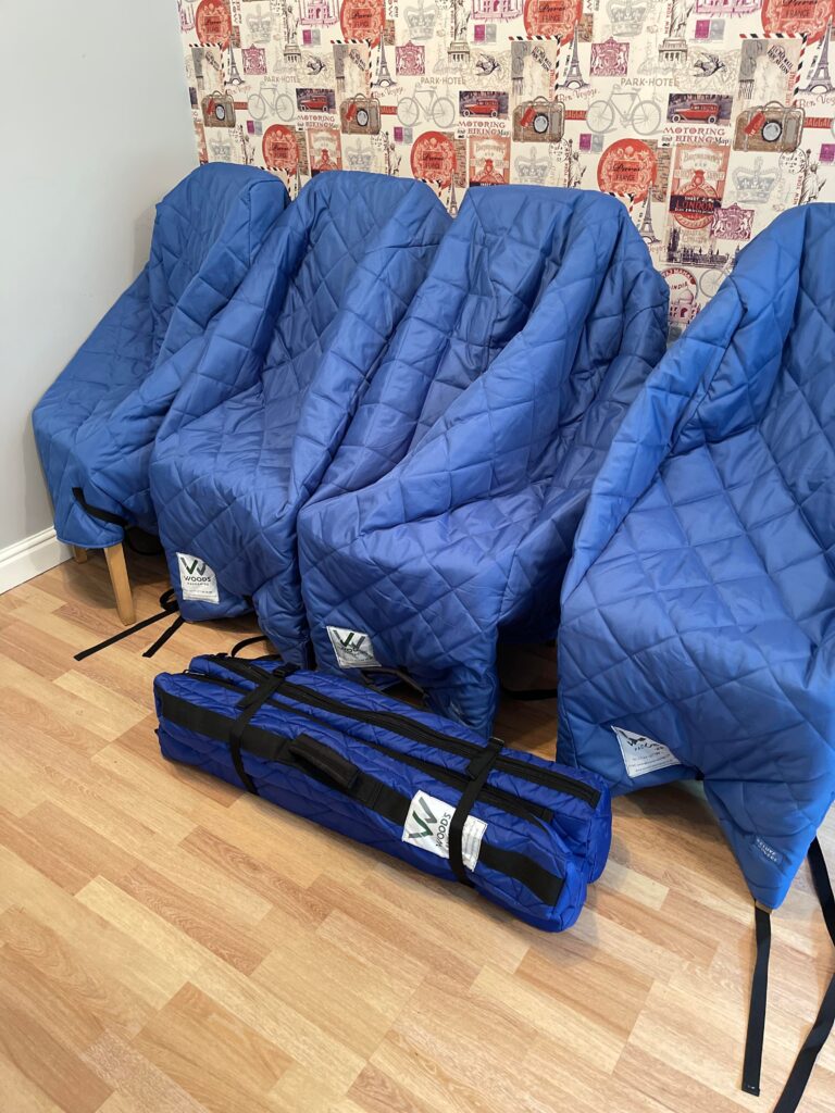Chairs wrapped in blue quilted moving blankets for protection during a house removal by Craig Atkinson Removals.