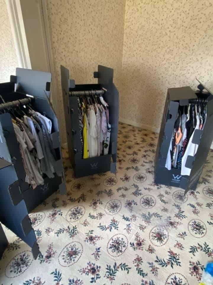 Wardrobe boxes neatly packed with hanging clothes as part of Craig Atkinson Removals’ professional packing service.