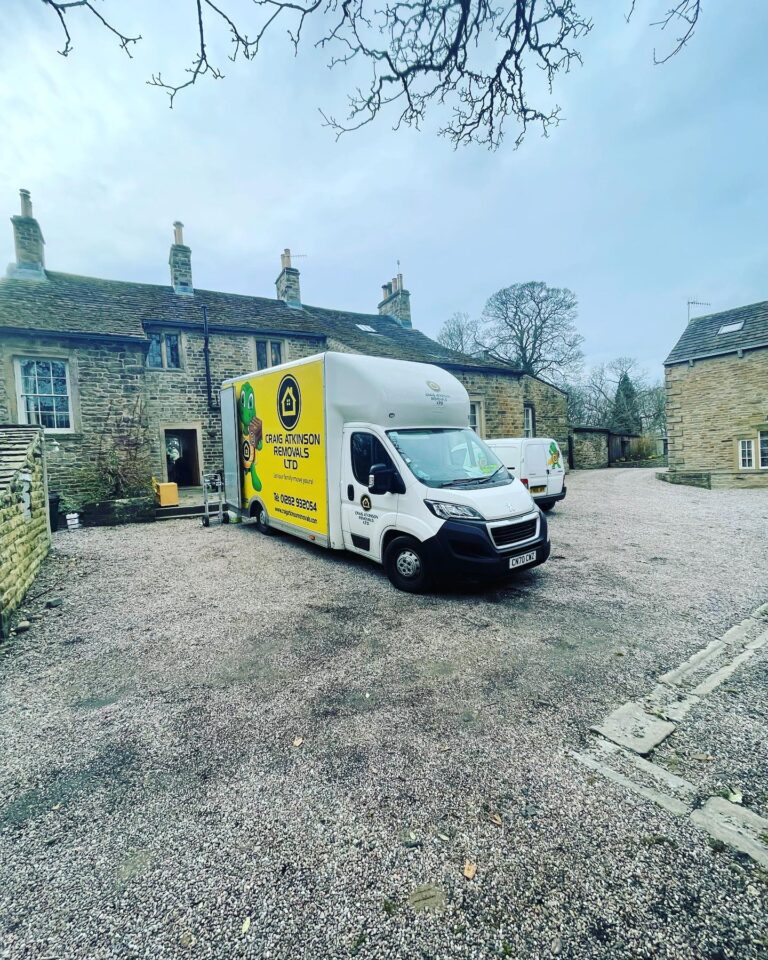 Craig Atkinson Removals van parked outside a stone house during a residential move in Lancashire
