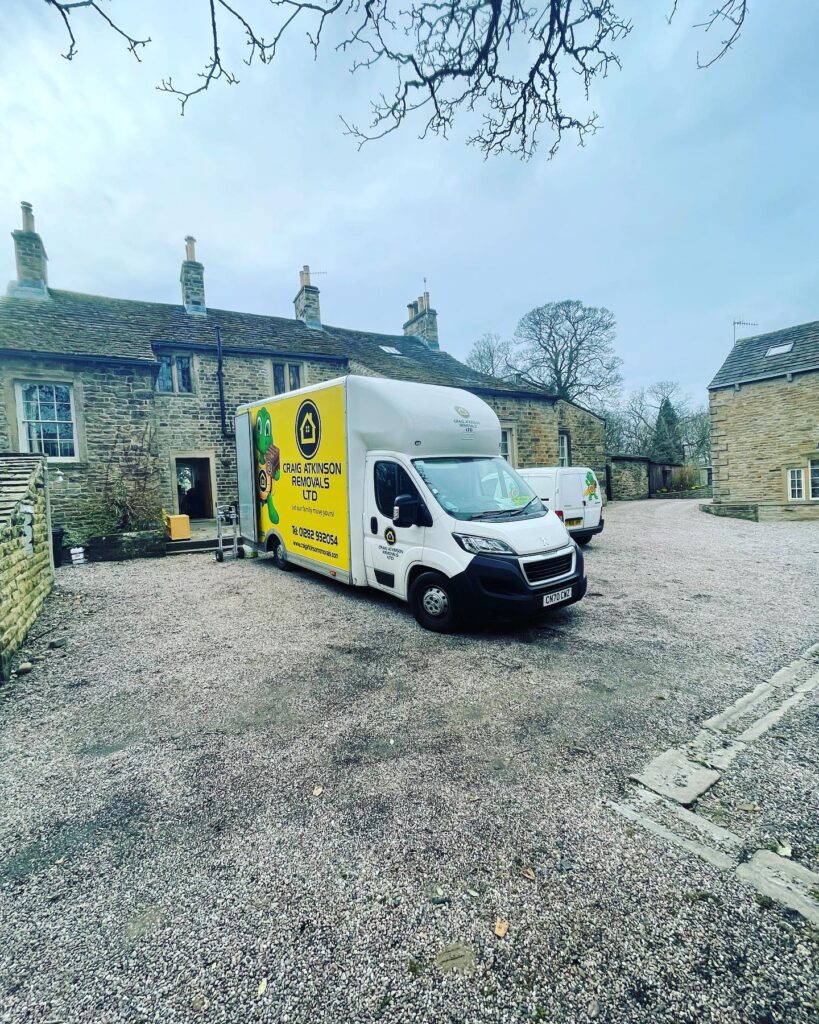 Craig Atkinson Removals van parked outside a stone house during a residential move in Lancashire