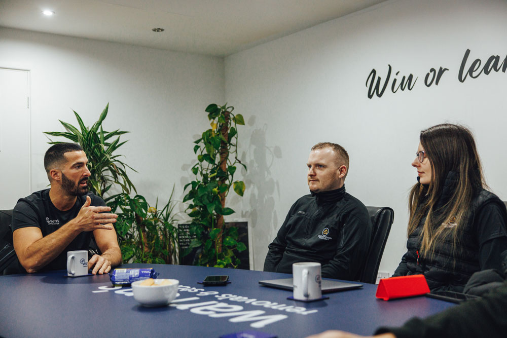 Craig Atkinson Removals and Warren’s Removals team members discussing ideas around a meeting table.