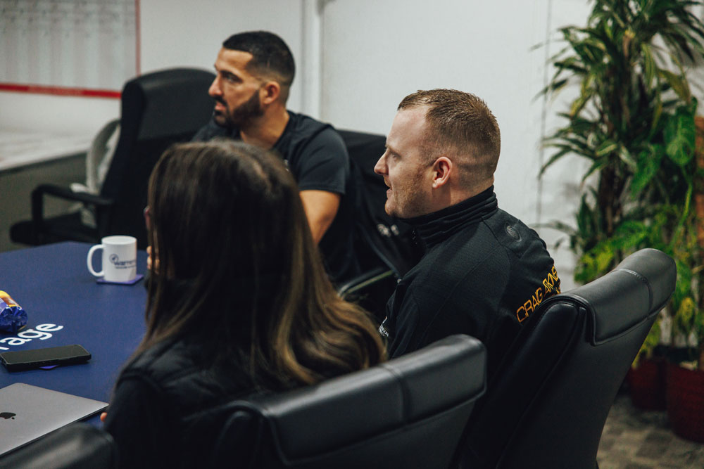 Craig Atkinson Removals team members in discussion around the table during meeting at Warren’s Removals HQ.