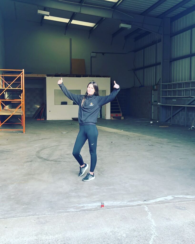 Craig Atkinson Removals team member celebrating inside the company’s new warehouse premises in Burnley.