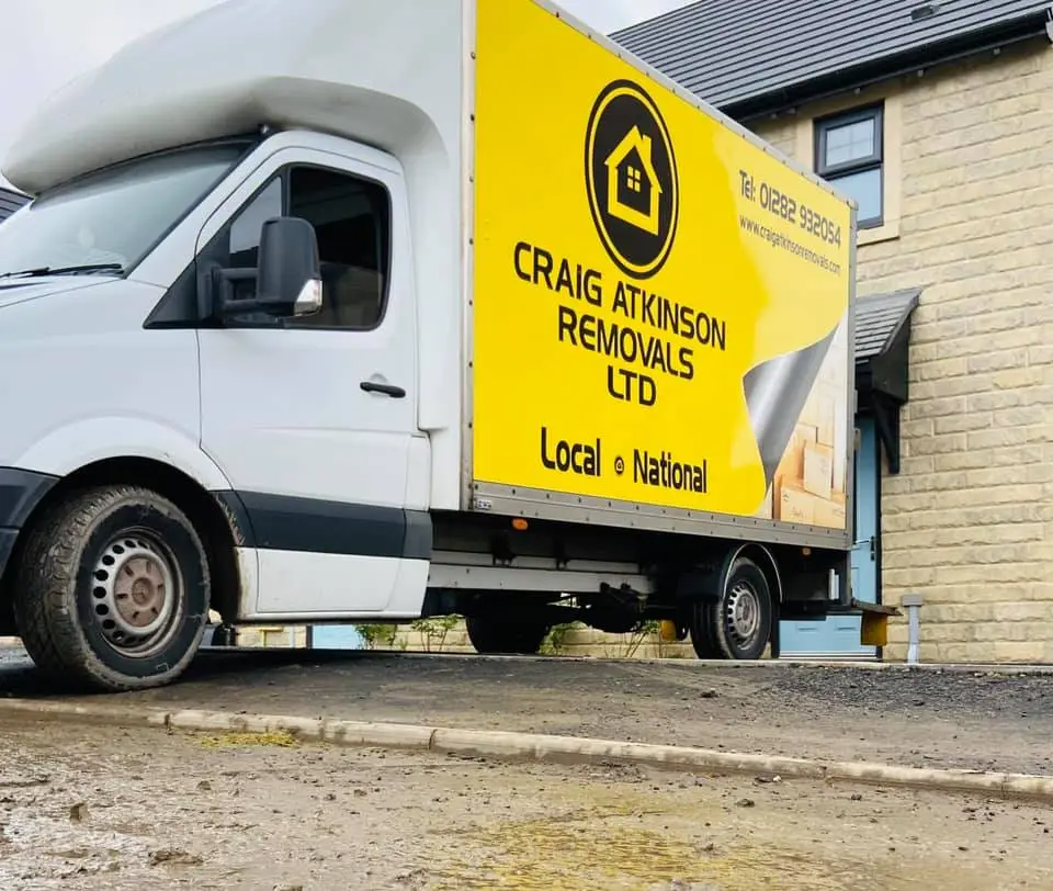 Craig Atkinson Removals van parked outside a modern stone-built home in Worsley during a local house move.