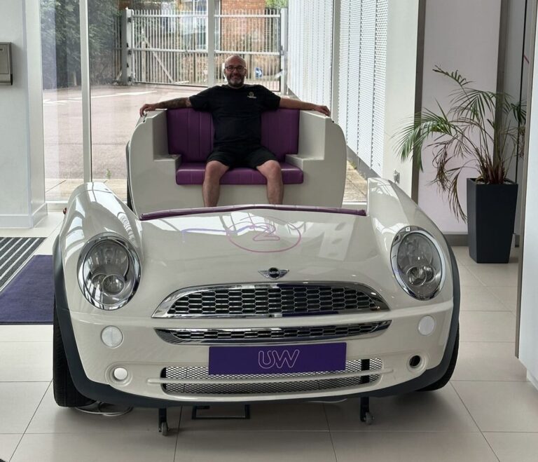 Craig Atkinson Removals team member sitting in a car-themed seat at Utility Warehouse’s London office.