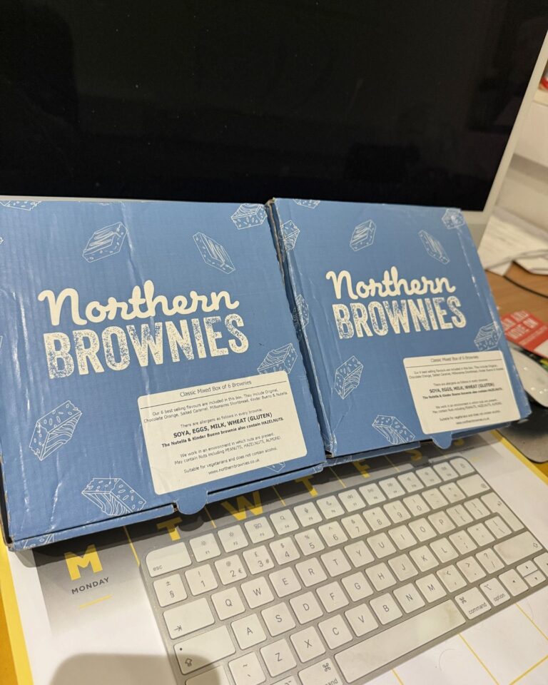 Two Northern Brownies boxes on a desk, gifted as a thank you treat to the Craig Atkinson Removals team.