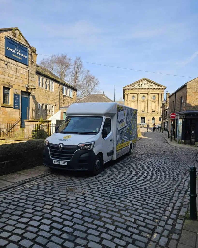 Craig Atkinson Removals van parked on York Street in Clitheroe near The Royal George pub and United Reformed Church.