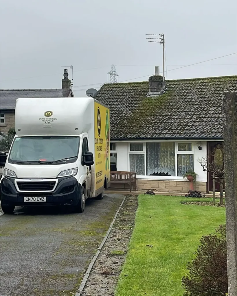 Craig Atkinson Removals van parked outside a bungalow during a local house move in Lancashire.