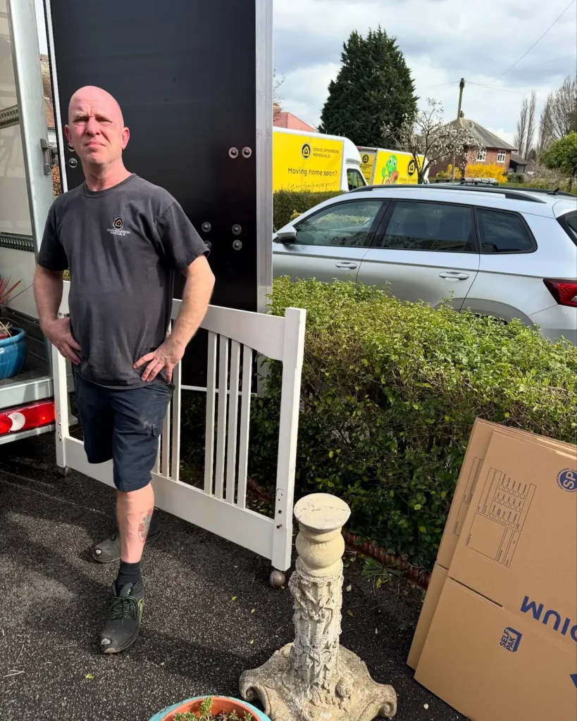 Craig Atkinson Removals team member standing beside the removals van during a house move in Lancashire.