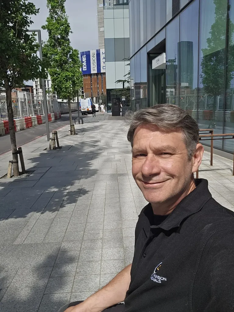 Mark from Craig Atkinson Removals smiling in uniform on location during a removal job.