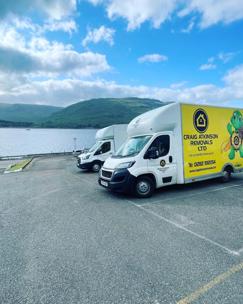 Craig Atkinson Removals vans parked by the water in Fort William, Scotland during a long-distance house move
