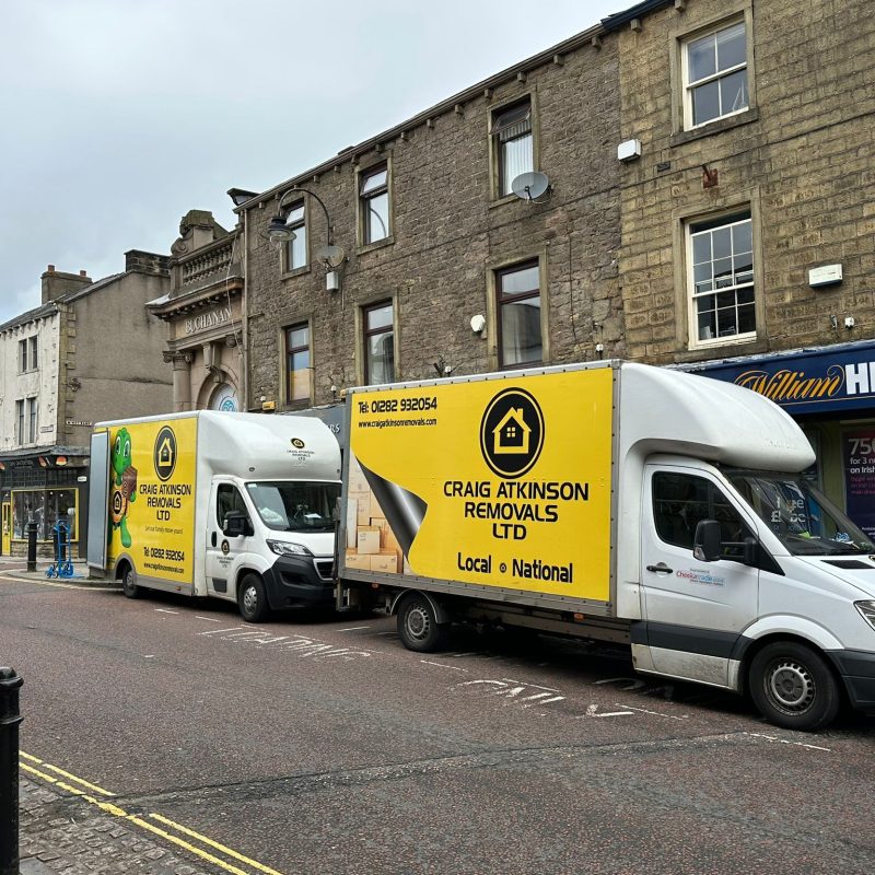 Craig Atkinson Removals vans parked on Albert Road in Colne during a local house and business move.