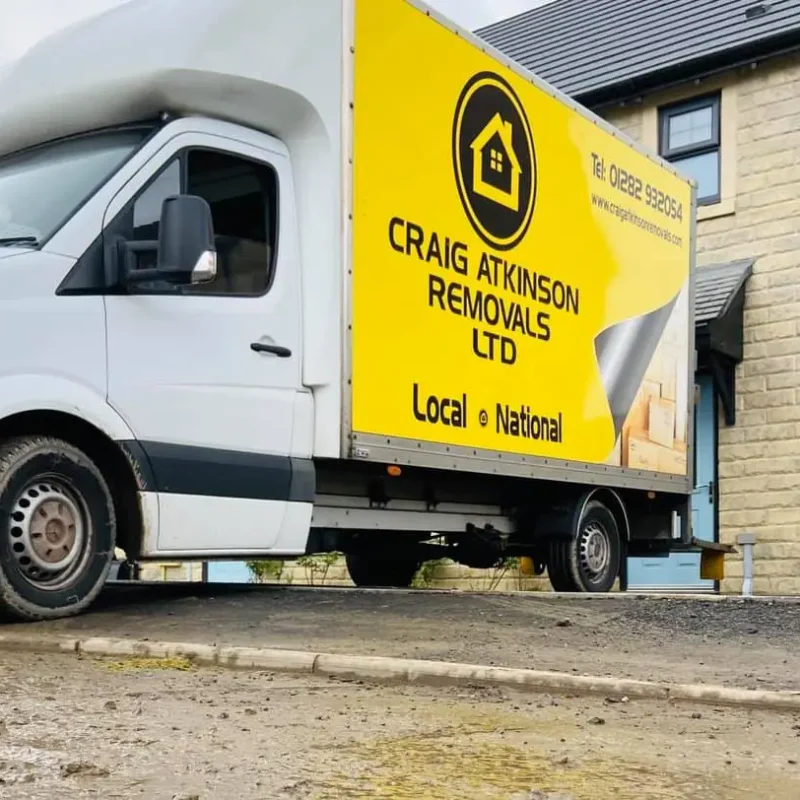 Craig Atkinson Removals van parked outside a modern stone-built home in Worsley during a local house move.